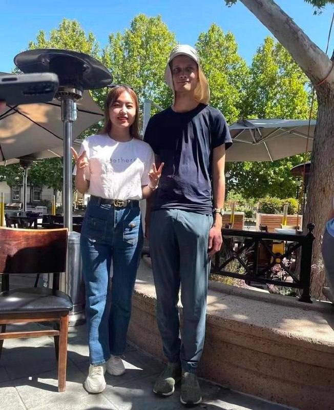 Two people standing together outdoors